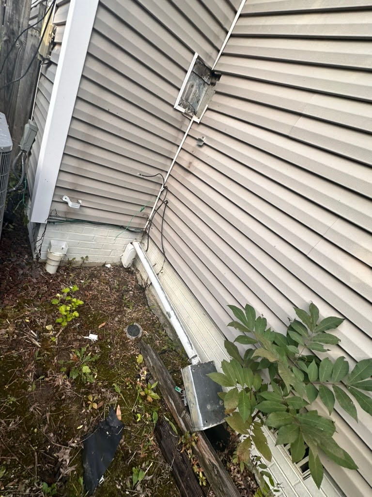 Professional electrician installing surge protector to safeguard home electronics from storm damage, TriCities Electric